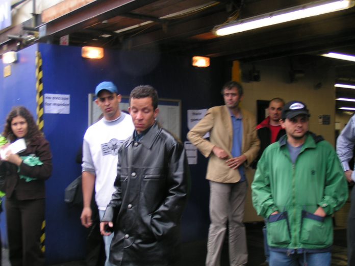 ALEX ALVES PEREIRA (centre, foreground), grieving and angry cousin of Jean Charles de Menezes, accus