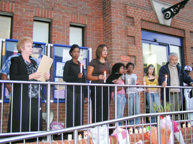 Friends and family of Paul Coker outside Plumstead police station on Tuesday evening – one month after he died. A minute’s silence was held as a mark of respect