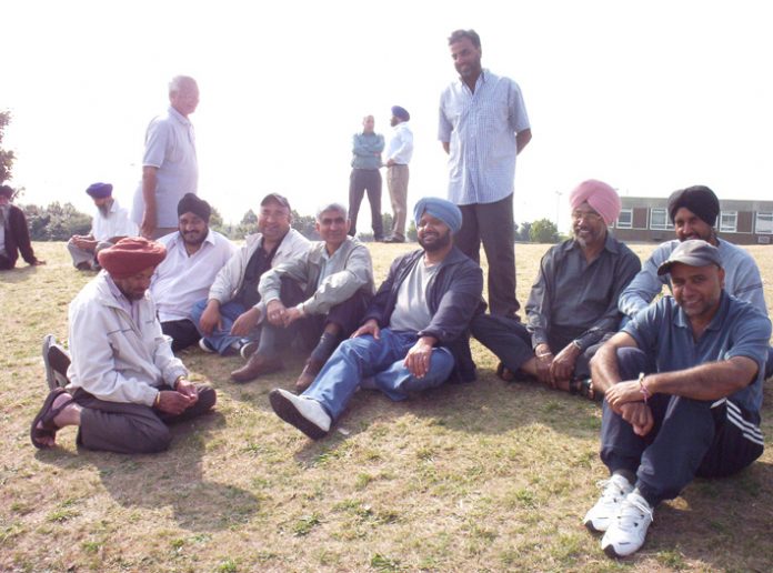 The striking Gate Gourmet workers fighting for reinstatement relaxing at the weekend. All except six pickets are being kept on a grass verge by a roundabout near to the factory