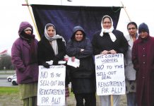 Locked-out Gate Gourmet workers on the picket line at the Beacon roundabout near the factory yesterday midday