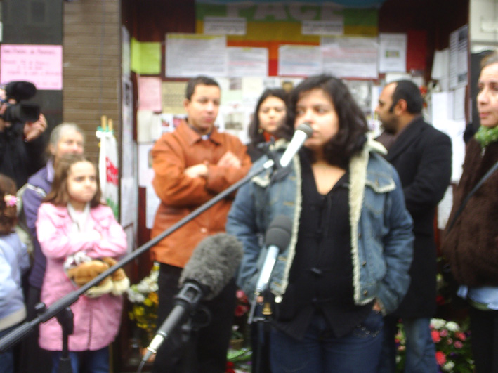 PATRICA DA SILVA ARMANI (speaking), ALEX PERIERA and VIVIEN MENEZES FIGUEIREDO (behind), cousins of Jean Charles de Menezes at the Stockwell Tube vigil six months after he was shot dead by police