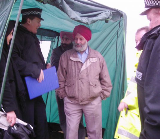 Police forcing the  Gate Gourmet locked-out workers to dismantle their tent and quit picketing Beacon Hill, Heathrow Airport after Gate Gourmet and the TGWU told the police that the dispute was over