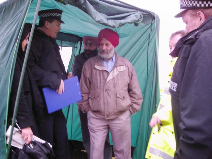 Police forcing the  Gate Gourmet locked-out workers to dismantle their tent and quit picketing Beacon Hill, Heathrow Airport after Gate Gourmet and the TGWU told the police that the dispute was over