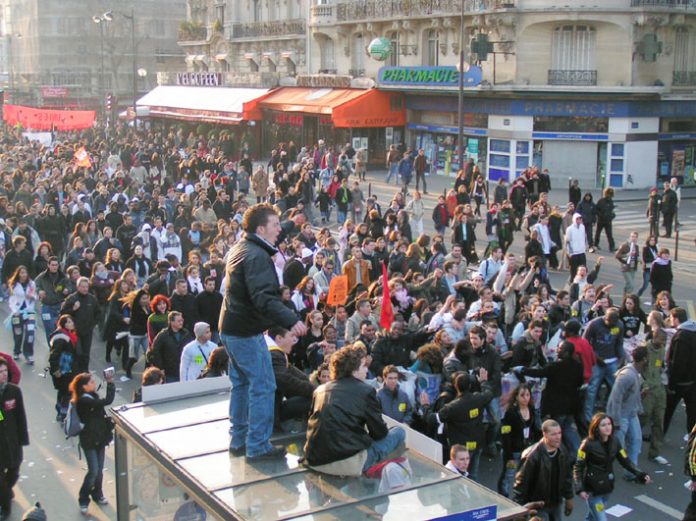 Huge crowds are cheered on their way to Place de la Nation on Saturday March 18 where they were confronted by squads of CRS riot police who mounted baton charges at workers and youth standing in the central reservation