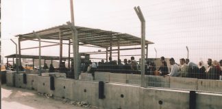 Palestinians queue at the Qalandiya Israeli army checkpoint on the outskirts of Ramallah – Israel now declare it to be a frontier post