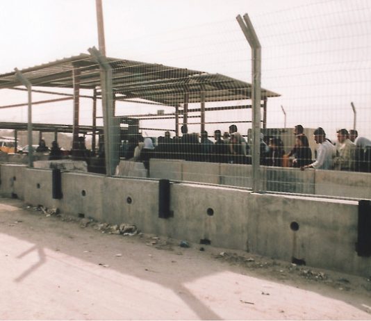 Palestinians queue at the Qalandiya Israeli army checkpoint on the outskirts of Ramallah – Israel now declare it to be a frontier post