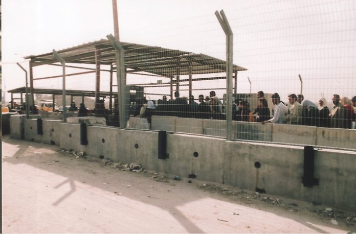 Palestinians queue at the Qalandiya Israeli army checkpoint on the outskirts of Ramallah – Israel now declare it to be a frontier post