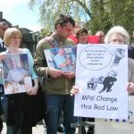 Relatives and widows of asbestos-related cancer victims outside the Houses of Parliament yesterday afternoon