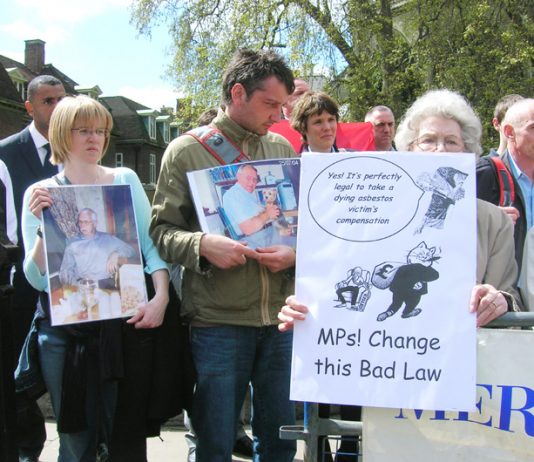 Relatives and widows of asbestos-related cancer victims outside the Houses of Parliament yesterday afternoon