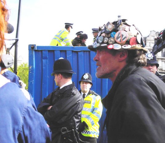 Parliament protester of 5 years BRIAN HAW, on Tuesday morning in front of a skip where all his documents and placards were thrown after a force of 50 police seized them in the early hours