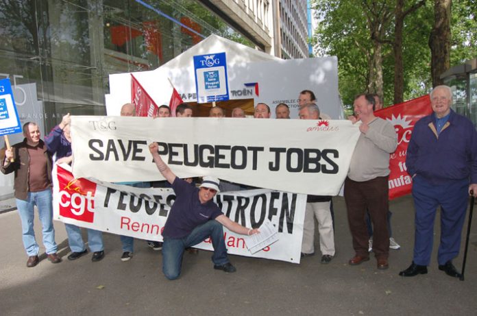 French and British workers with the CGT and TGWU/Amicus banners deliver a clear message to Peugeot shareholders