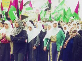 Hamas and Palestinian flags at a funeral in Ramallah for youth killed by the Israeli occupation forces