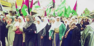 Hamas and Palestinian flags at a funeral in Ramallah for youth killed by the Israeli occupation forces