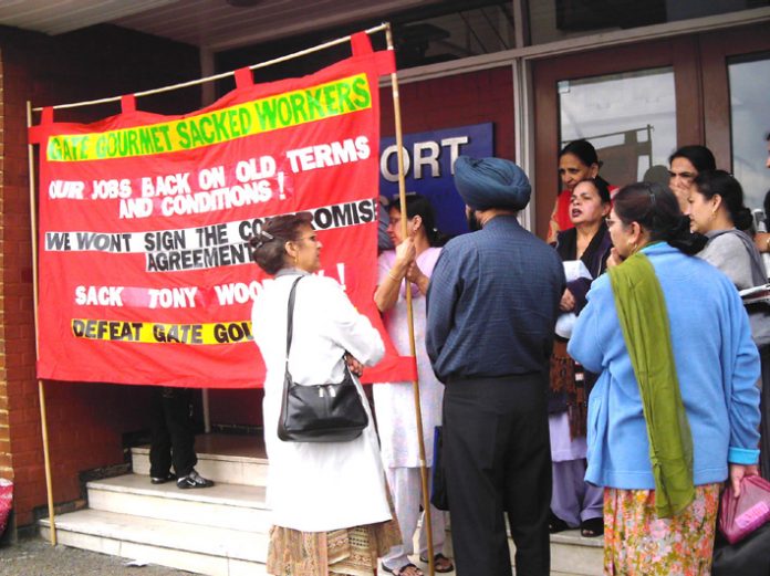 Gate Gourmet locked-out workers yesterday angrily confronting their TGWU convenor Dhillon, outside the Hillingdon TGWU office demanding that their dispute must be made official and that they must also receive dispute pay