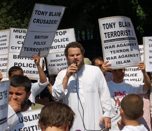 Demonstrators in Forest Gate denounce Blair as the terrorist and demand the police apologise for the raid on a local working class family