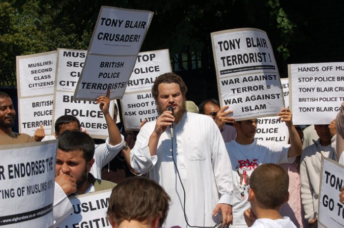 Demonstrators in Forest Gate denounce Blair as the terrorist and demand the police apologise for the raid on a local working class family