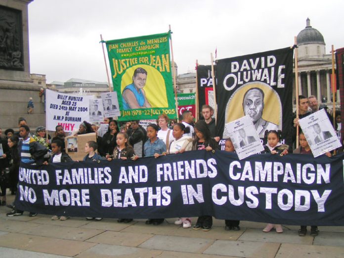 United Families and Friends marchers assemble for their anniversary march in Trafalgar Square last October (above) and (below) banners with names of those who were killed whilst in prison, on the march to Downing Street