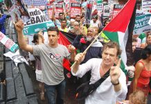 Demonstrators expressing their anger as they passed the US embassy in London on the 30,000-strong march demanding an end to the Israeli attack on the Lebanon