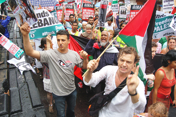 Demonstrators expressing their anger as they passed the US embassy in London on the 30,000-strong march demanding an end to the Israeli attack on the Lebanon