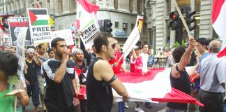 Marchers carrying the Lebanese flage denounce the US and Israel on last Saturday’s 30,000-strong march in central London