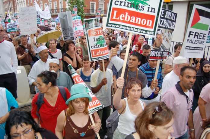 Marchers in London on July 22 condemn the Israeli crimes in Lebanon and Palestine