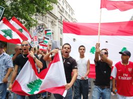 Angry Lebanese youth marching with their flags in London on July 22