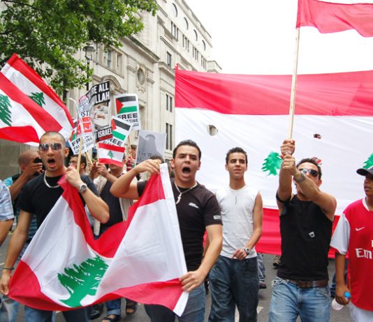 Angry Lebanese youth marching with their flags in London on July 22
