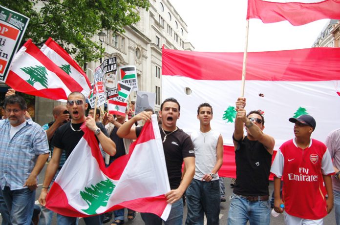 Angry Lebanese youth marching with their flags in London on July 22
