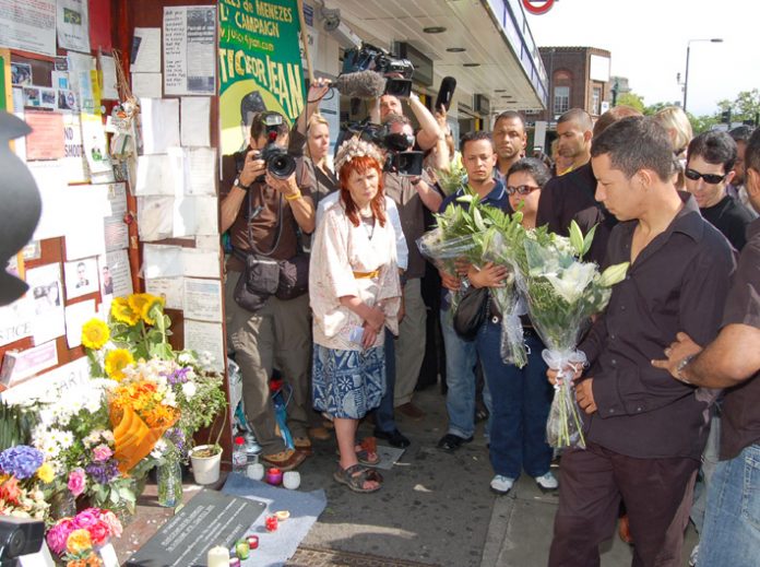 Alex Pereira (right) lays flowers at the shrine outside Stockwell station for his cousin Jean Charles de Menezes on the first anniversary of the young Brazilian man’s shooting by armed police on July 22, 2005