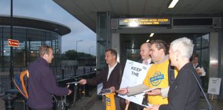 RMT general secretary BOB CROW (holding placard) and TSSA assistant general secretary MANUEL CORTES (wearing T-shirt) handing out leaflets at Canada Wharf