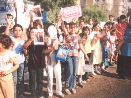 Crowds of Iraqis show their support for Saddam Hussein during the referendum on his rule in November 2002