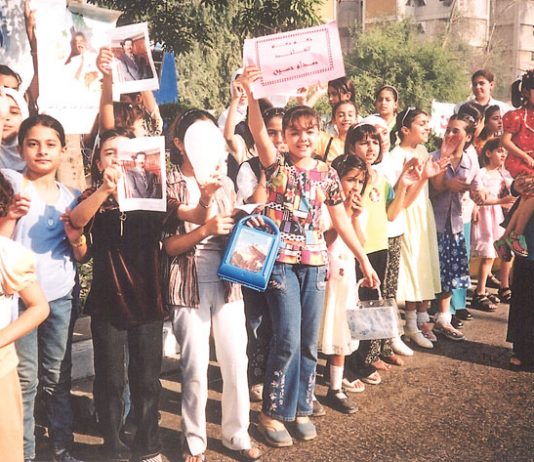 Crowds of Iraqis show their support for Saddam Hussein during the referendum on his rule in November 2002