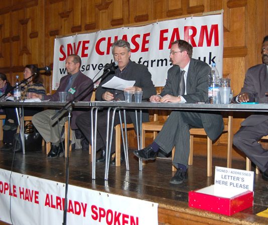 Platform of Saturday’s packed ‘Save Chase Farm’ meeting, (L-R) consultant ANNA ATHOW, Maternity Liaison Committee member Gail McCONNELL, Ambulanceman Jonathan FOX, chair STEPHEN ARMSTRONG, Save Chase Farm councillor KIERAN McGREGOR, local GP Dr NICHOLAS P