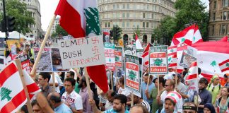 Demonstrators in London on July 27 last year condemn Olmert and Bush for their crimes in Lebanon