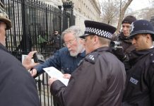 Police read out a passage from the Serious Organised Crime and Police Act to Nicholas Wood outside Downing St