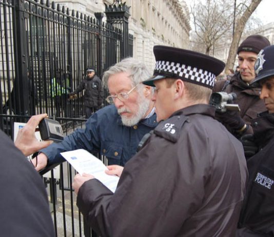 Police read out a passage from the Serious Organised Crime and Police Act to Nicholas Wood outside Downing St