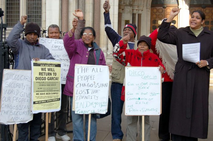 Chagossians in defiant mood outside the Royal Courts of Justice in the Strand on Monday, including Hengride Permal (right)