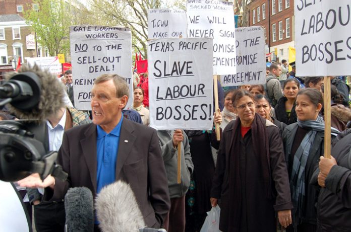 TGWU general secretary TONY WOODLEY surrounded by sacked Gate Gourmet workers angry at the sell-out ‘Compromise Agreement’ made between the TGWU leaders and Gate Gourmet bosses