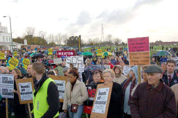 Rally to defend St Helier and Epsom hospitals last November when there were protests about patients being served cold meals  – now St Helier Trust  is removing light bulbs to cut bills