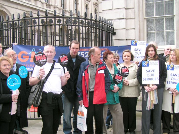 Trade unionists and local campaigners fighting the massive cuts at Derriford Hospital in Plymouth outside Downing Street yesterday, where they handed in a 12,000-strong petition against 60 more bed closures in a £25m cuts package