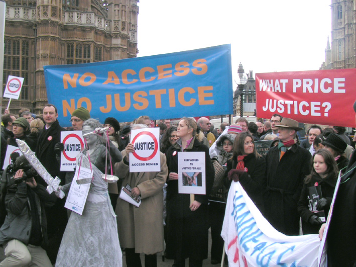 ‘Justice with her sword’ stands blindfolded among a crowd of hundreds of legal aid lawyers outside parliament on Monday