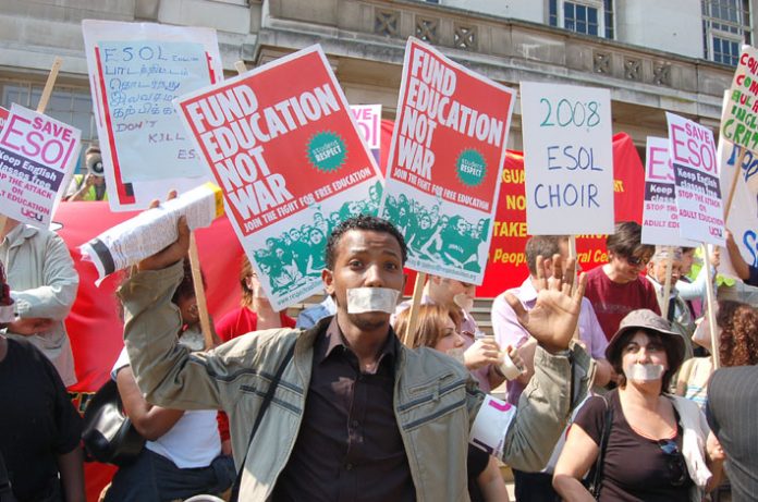 ESOL students taped up their mouths to show their anger at being denied free access to English language classes