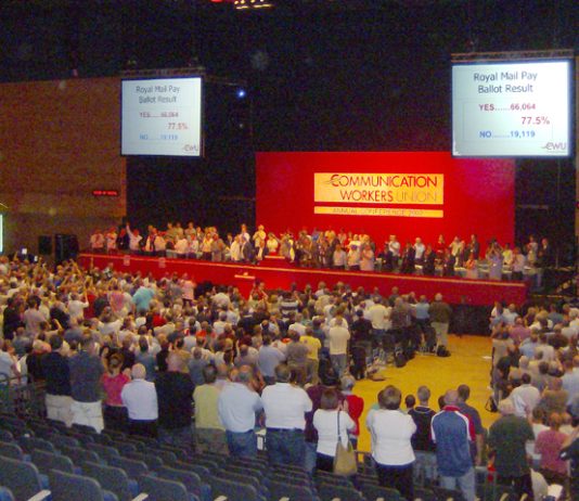 Delegates at the CWU conference applaud the 77.5 per cent vote for strike action at Royal Mail to defend their pay and conditions