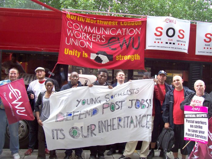 Postal workers supported by Young Socialists demonstrate outside the Royal Mail headquarters in Old Street yesterday at midday