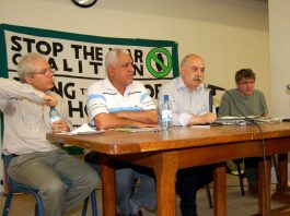 The platform at Wednesday night’s meeting (left-right) SAMI RAMADANI, IFOU President HASSAN JUMAA AWAD AL-ASSADI, meeting chairman SABAH JAWAD and ANDREW BURGIN (Stop the War Coalition)