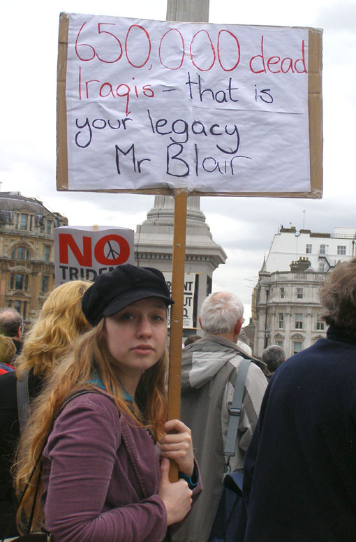 A demonstrator in London reminds Blair of the legacy that he brings as the new ‘Middle East envoy’