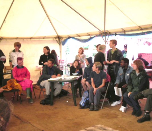 Young people in one of the tents in the camp discussing their activities for the day