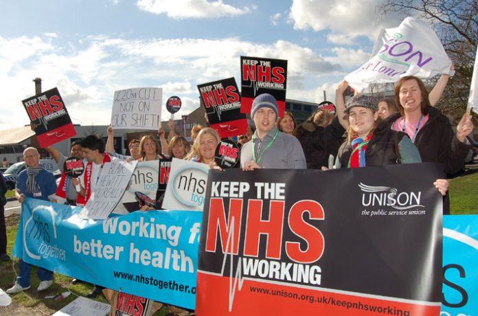 Health workers demonstrating against cuts outside Kingston Hospital in March this year