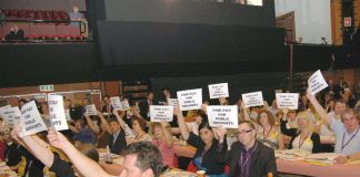 A section of delegates at the TUC Congress greet Brown with their placards