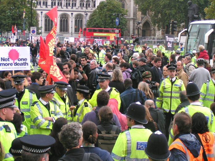 The police lines open and the marchers pour through, heading for a demonstration in Parliament Square, opposite the House of Commons
